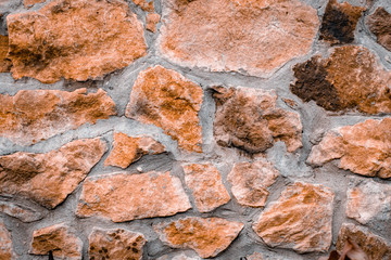 The texture of the stone wall. Background of the old masonry stone with cement.