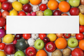 Fototapeta na wymiar Fresh fruits and vegetables with blank card on light background, flat lay. Space for text