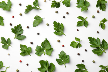 Flat lay composition with green parsley and pepper on white background