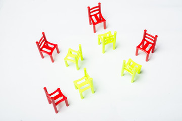 The concept of negotiation, discussion, communication, learning. A lot of multi-colored chairs on a white background.