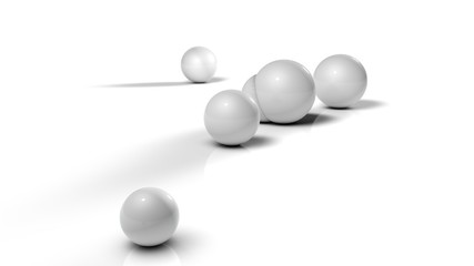 3D illustration of white balls on white reflective background. Balls of different sizes are rolled in different directions. Futuristic image for background and desktop 3D rendering with depth of field
