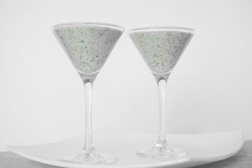 Smoothies green on the table in two glasses