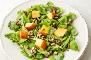 Purslane Salad with Peach Fruit, Roasted Walnuts and Pine Nuts.