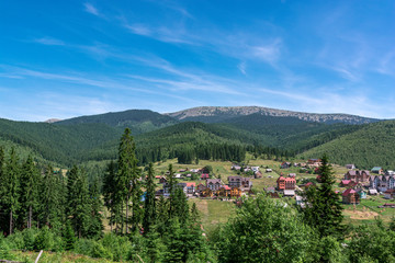 Beautiful summer landscape wint mountains. Carpatian village at mountains