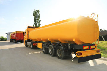 Modern bright trucks parked on country road