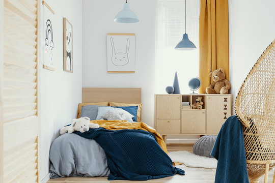 Stylish Wooden Commode In Bright Bedroom Interior With Poster On The Wall