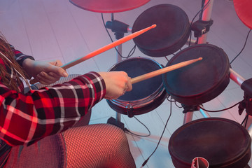 Rock, music and hobby concept - drummer's foot wears sneakers pushing drum bass pedal