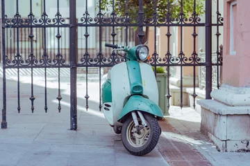 Outdoor kussens Scooter standing at the intricate metal fence © Николай Батаев