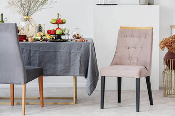 Stylish chair next to elegant dining table set for party