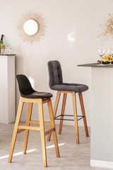 Vertical view of two fashionable bar stools in elegant bright interior