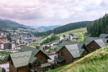 Obraz premium Village in the Mountains. Carpatian village with hotels and sports ground in the Mountains