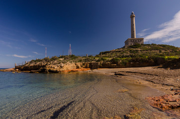 Fototapeta premium Faro de Cabo de Palos, located on a small peninsula in Cartagena (Murcia) Spain