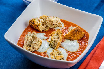 Fire roasted tomato soup with basil cream and herby croutons. Calgary, Alberta, Canada