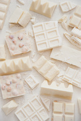 Variety of white chocolate on a light background