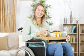 disabled woman in wheelchair having breakfast