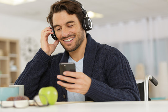 Young Handsome Man In Wheelchair On The Phone