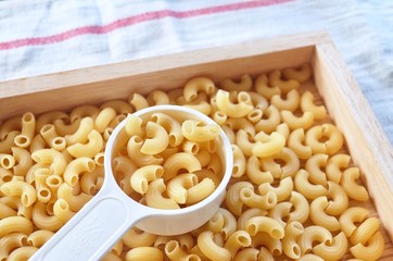 Dried Elbow Macaroni in A Measuring Cup