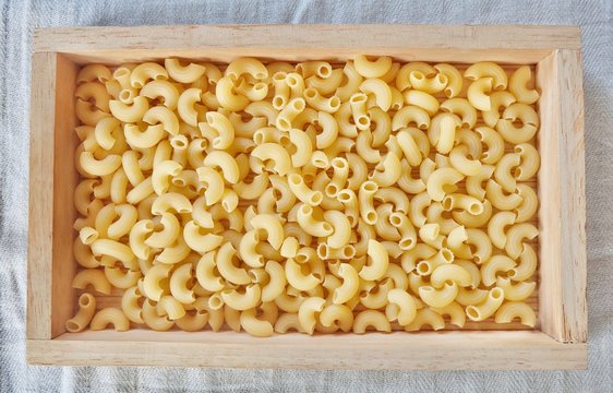 Dried Elbow Macaroni in A Wooden Tray