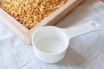 Yellow Dried Soybeans with Empty Measuring Spoon