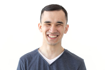 Expression and gesture concept - Portrait of laughing asian man on white background