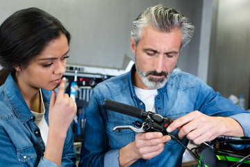 portrait of bicycle mechanic with customer