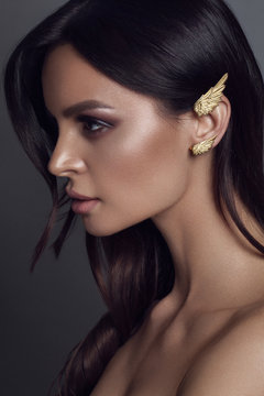 Beautiful young woman with kaffa in the ear. Make up and Jewellery concept - Image