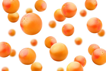 Falling grapefruits isolated on white background, selective focus