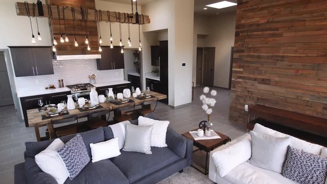 Living Room and Kitchen Lower to Coffee Table Wide. view moves down on a wide angle of open floor plan livingroom and kitchen to coffee table in living room