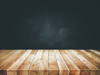Empty wood table top counter on dark wall background.For create product display or design key visual