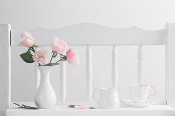 pink roses on vintage wooden white shelf