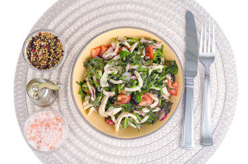 Salad of lettuce leaves, tomatoes and squid. 