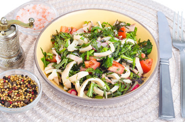 Salad of lettuce leaves, tomatoes and squid. 