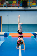 Little gymnast in a competition