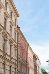 Fototapeta premium Multi storey beige and white stone apartment houses in a town street.