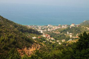 Obraz premium Village in the mountains on the blue sea. Travel to the southern countries
