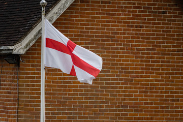 English flag in front of a brick wall in the UK