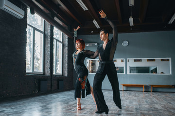 Elegance man and woman on ballrom dance training