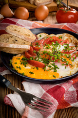 Homemade breakfast fried egg with tomato.