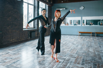 Couple on ballrom dance training in class