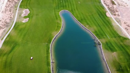 Golf Course Aerial Looking Down Along Pond. aerial view looking down on a golf course in the southwest desert with pond