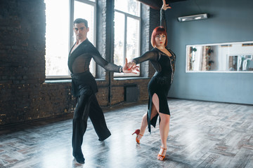 Couple on ballrom dance training in class