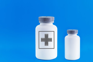 Two empty pill bottles. Beautiful blue background, modern medicine used for disease prevention and treatment, copies the space.