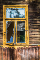 Abandoned wooden building with a broken window