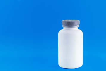 Empty pill bottle. Beautiful blue background