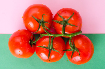 Creative layout of tomatoes on bright background.