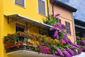 Typical Italian balcony with flowers. Balcony decoration.