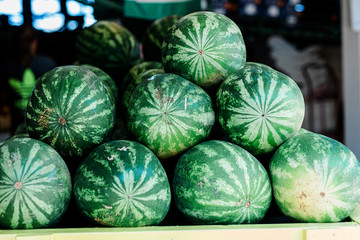 Box of Watermelons on a Fruit Stand at A Farrmer's Market Orchard in the Summer