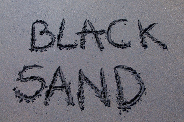 Black sand inscription drawn on black sand
