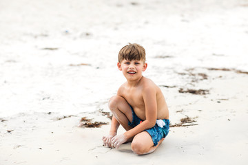 Little Boy Playing in the Sand on the Beach in Florida During the Summer
