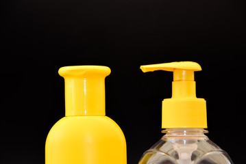 A bottle of household chemicals cosmetics on a black background neck of a bottle close up macro...